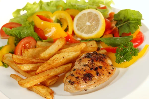 Lemon pepper chicken and fries — Stock Photo, Image