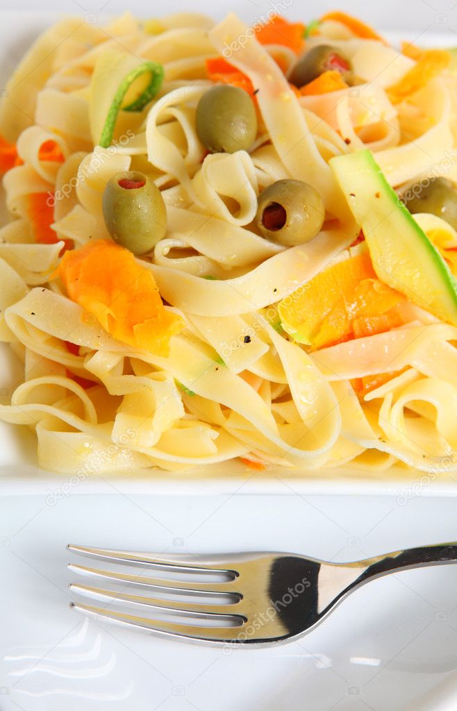 A plate of tagliatelle with ribbons of carrot and courgette