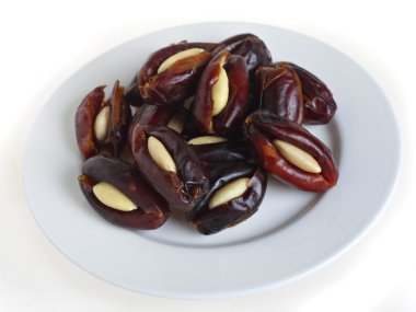 Almond stuffed dates on a plate clipart