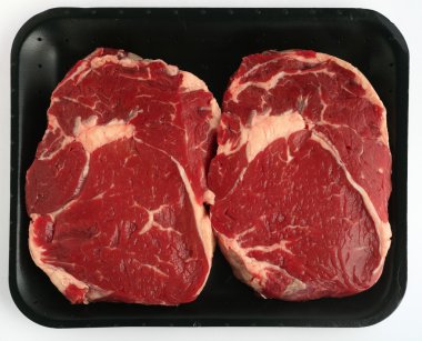 Two steaks on tray clipart