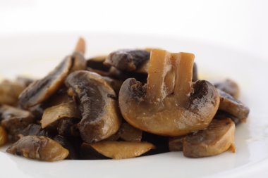 Sauteed mushrooms on plate clipart