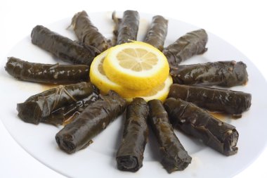 Stuffed vine leaves on a plate clipart