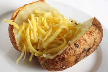 Baked russet potato with cheddar cheese clipart