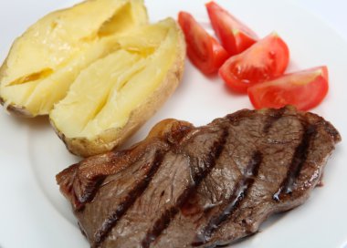 Grilled New York steak with veg clipart