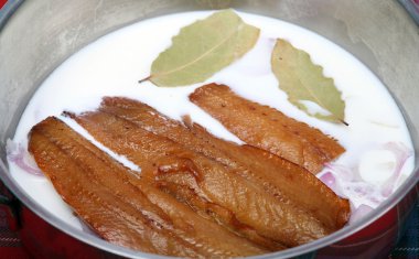 Kippers with milk and onion clipart