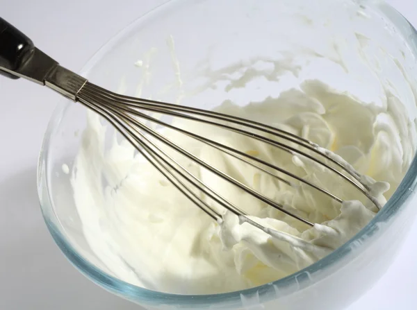 Whipping cream in a glass bowl — Stock Photo, Image
