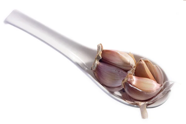 Garlic cloves on spoon — Stock Photo, Image