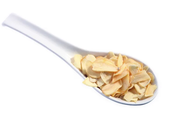Garlic slices on a spoon — Stock Photo, Image