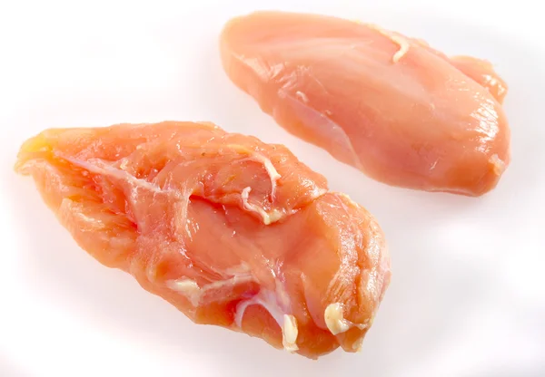 Raw chicken breasts on white — Stock Photo, Image