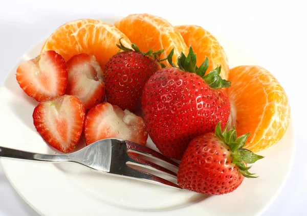Strawberries and tangerines with fork — Stock Photo, Image