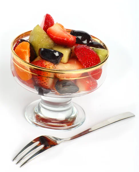 Чаша с фруктами и вилка — стоковое фото