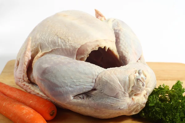 Raw turkey on a board — Stock Photo, Image