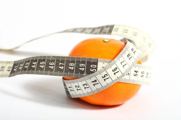 Metric tape measure and tangerine — Stock Photo, Image