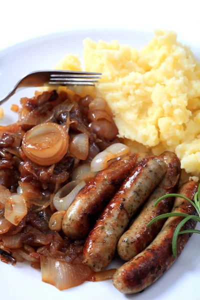Sausages fried onions and potato — Stock Photo, Image