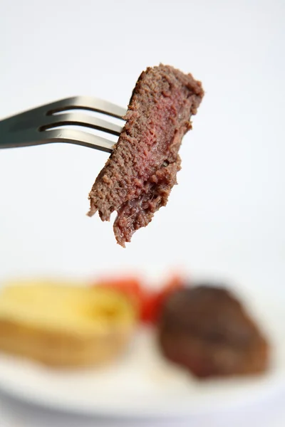 Pedaço de bife em um garfo — Fotografia de Stock