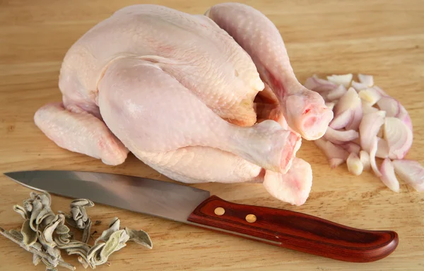 Chicken with sage, onion and knife — Stock Photo, Image