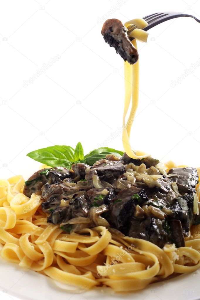 Fettuccini and mushroom on a fork