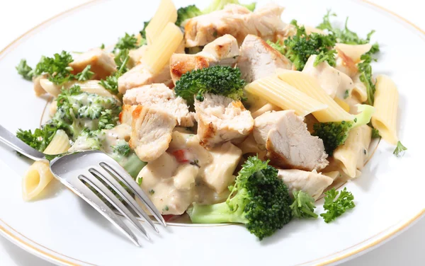 Grilled chicken with pasta and fork — Stock Photo, Image