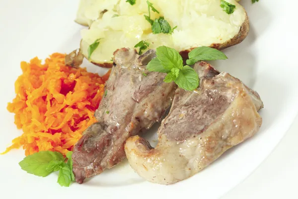 Lamb chops carrots and baked potato — Stock Photo, Image