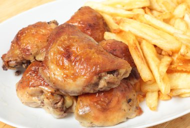 Roast lemon chicken thighs and fries clipart