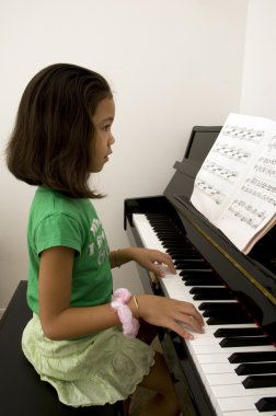 Kid playing piano clipart