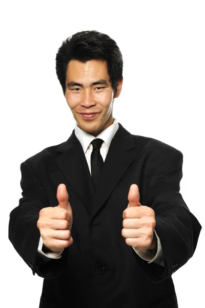 アジア系のビジネスマンの親指をあきらめるスーツ ストック画像