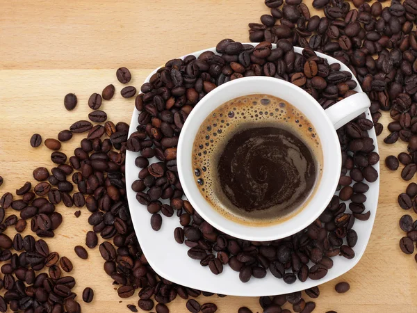 stock image Cup of coffee with coffee beans