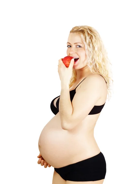 Piękna kobieta w ciąży, czerwone jabłko jedzenie — Zdjęcie stockowe