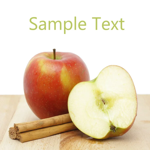 Apple and cinnamon sticks — Stock Photo, Image