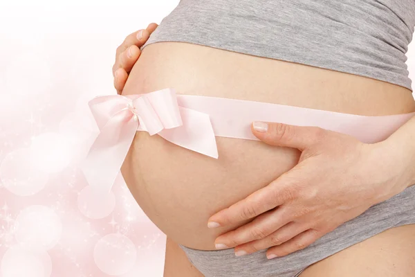 Pregnant woman embracing her belly — Stock Photo, Image