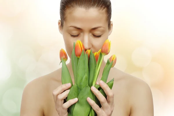 Beautiful young woman with tulips — Stock Photo, Image