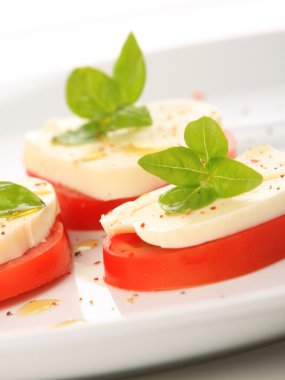 mozzarella ve fesleğen ile sunulan domates