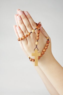 Hands in prayer with a rosary clipart