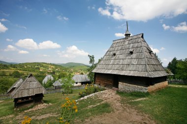 Traditional serbian houses in ethno-village clipart
