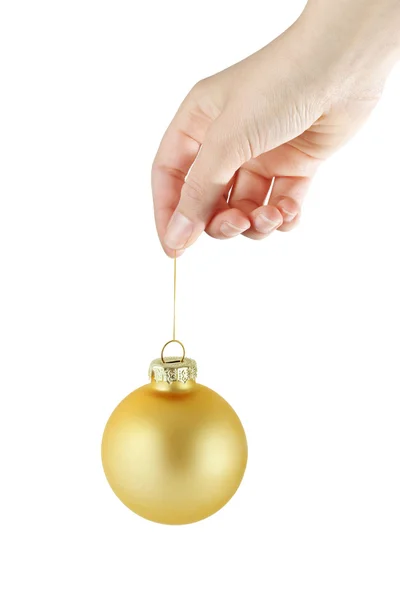 Female hand holding golden christmas baubl — Stock Photo, Image