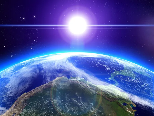 De zon en de aarde in de ruimte Stockfoto