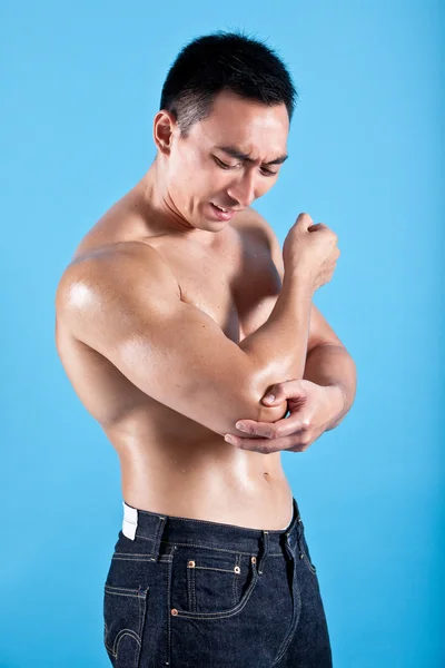 Fit man suffering from painful elbow injury — Stock Photo, Image