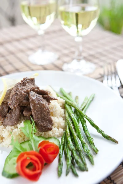 Delicious lamb cous cous with grilled asparagus — Stock Photo, Image