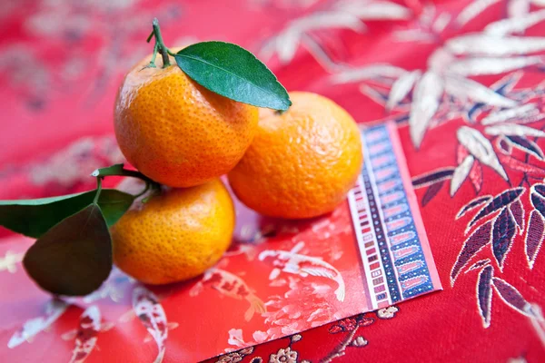 stock image Mandarin oranges with Chinese new year money packet