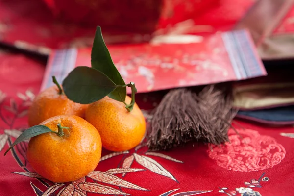 Мандаринские апельсины с китайским пакетом новогодних денег — стоковое фото