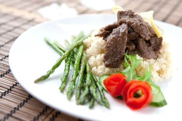 Lamb cous cous with asparagus — Stock Photo, Image