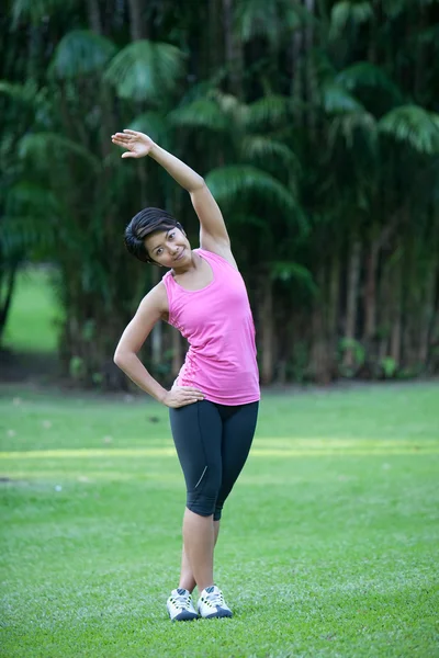 Active woman doing stretching exercise Stock Image