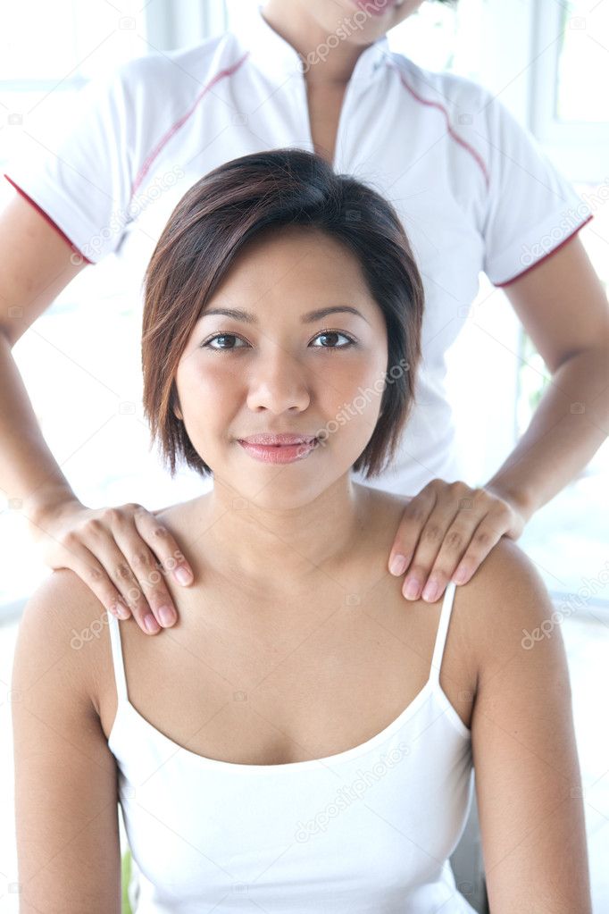 Asian woman receiving a shoulder massage
