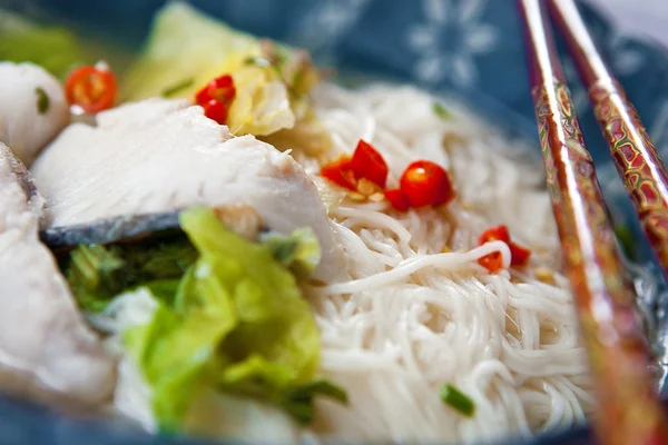 :Bowl of fish soup with noodles and lettuce. — Stock Photo, Image