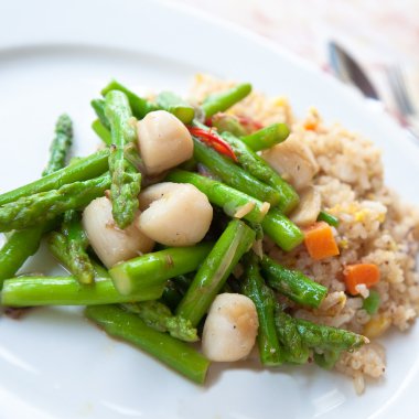 Delicious oriental fried rice with asparagus and scallops clipart