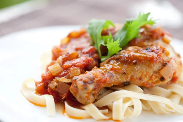 Italian chicken cacciatore served with pasta — Stock Photo, Image