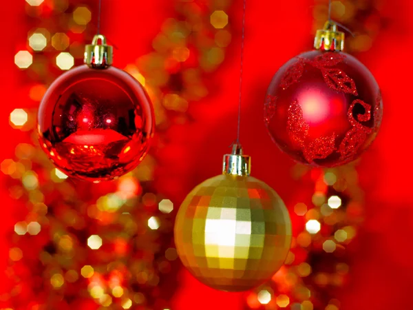 Gold Christmas decoration on red bokeh background — Stock Photo, Image
