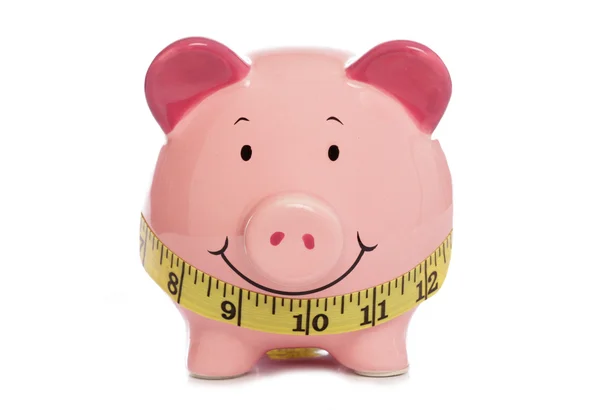 Piggybank con cinta métrica —  Fotos de Stock