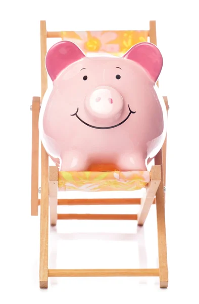 Piggy banco en la silla de cubierta —  Fotos de Stock