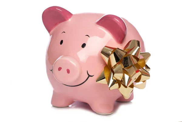 Christmas bow and Piggybank — Stock Photo, Image